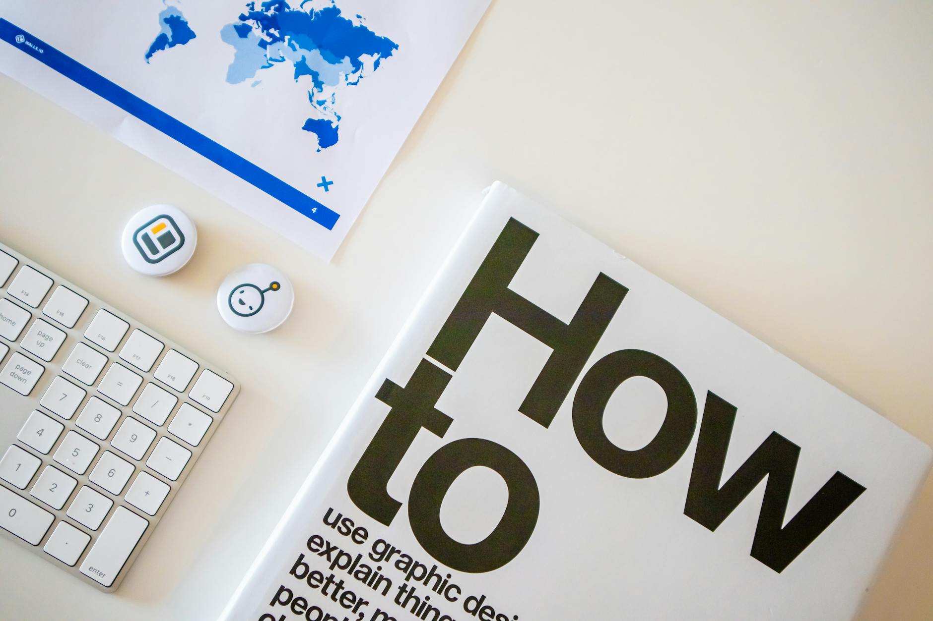 home desk with a design book stationary elements and marketing stats